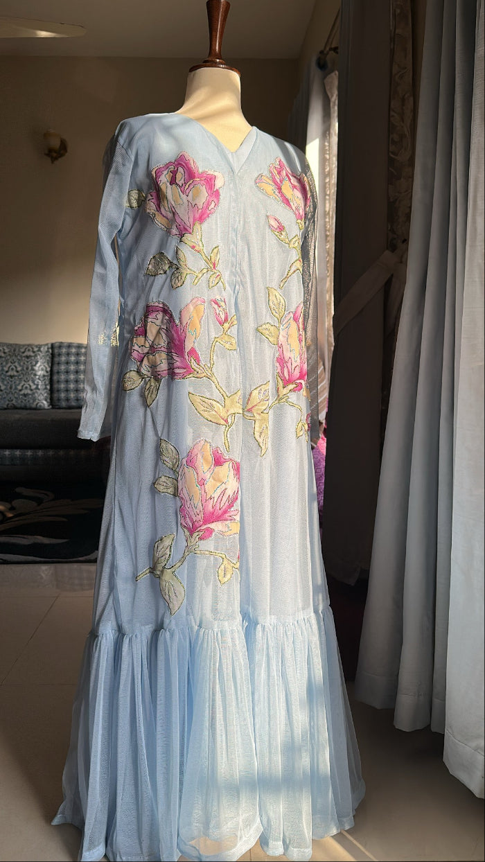 Light blue dress with floral embroidery on a mannequin against a neutral background