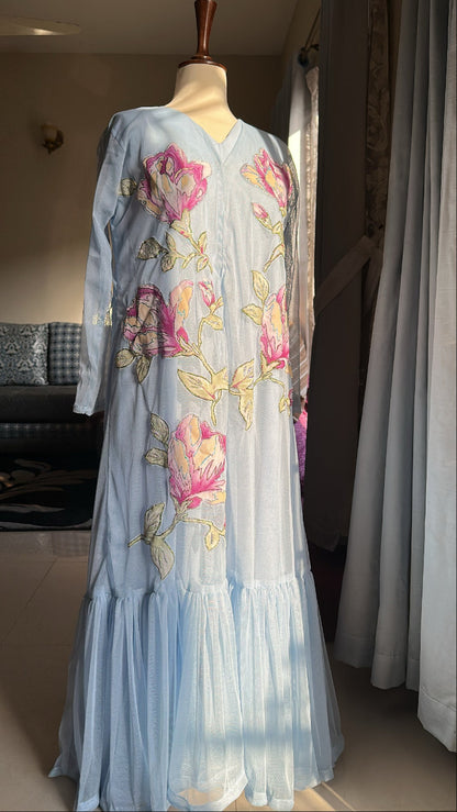 Light blue dress with floral embroidery on a mannequin against a neutral background