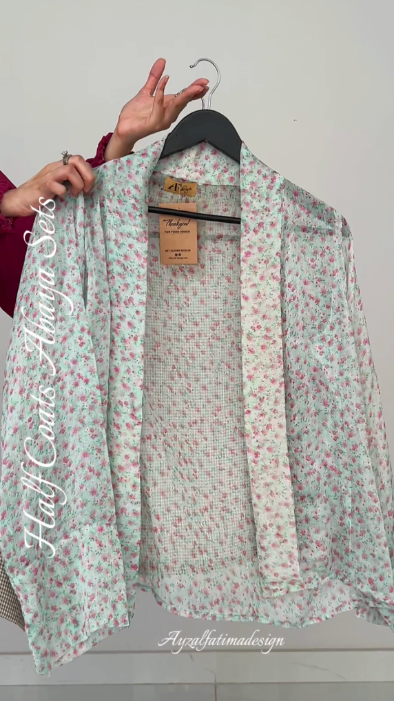 Floral-patterned shirt on a hanger with a visible brand label against a white background