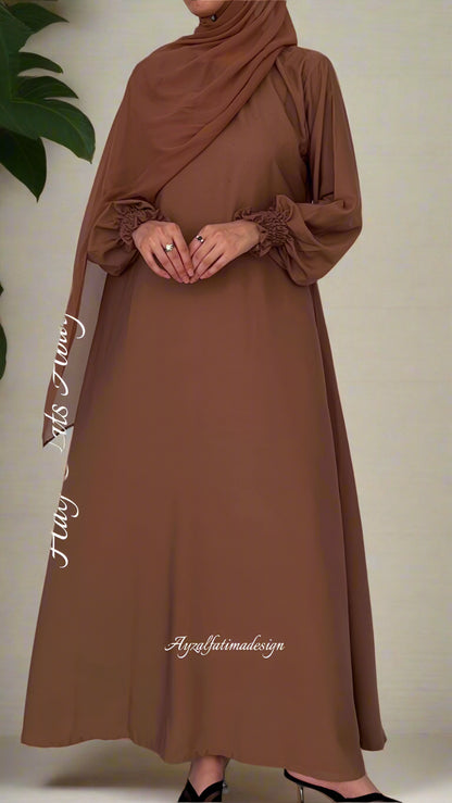 Brown abaya dress with long sleeves on a plain background