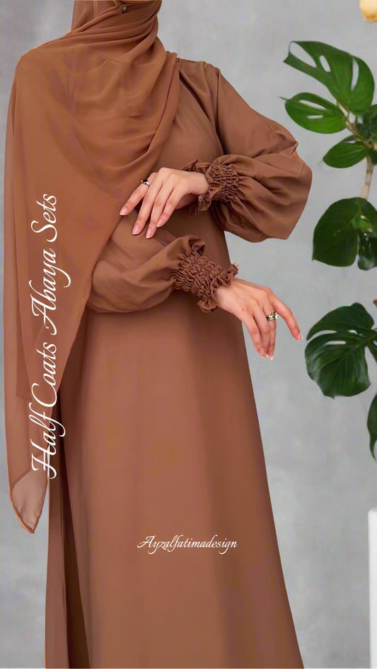 Brown abaya set with long sleeves and a hood on a white background