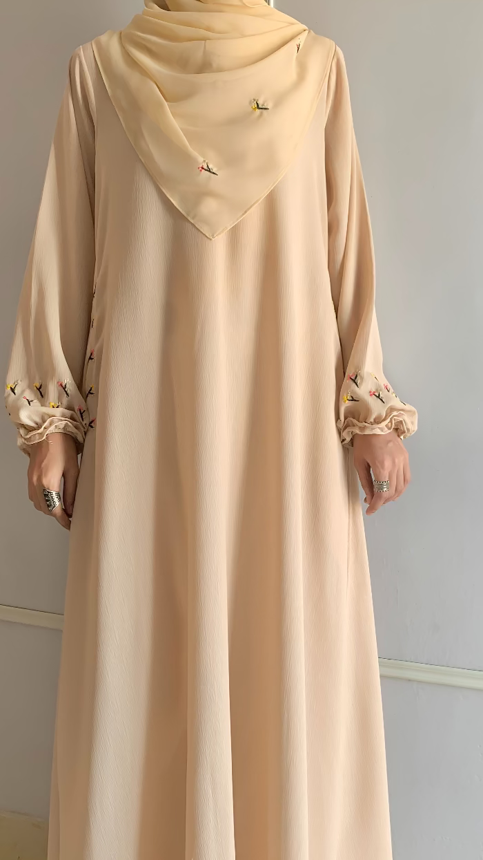 Beige dress with a matching hijab on a neutral background