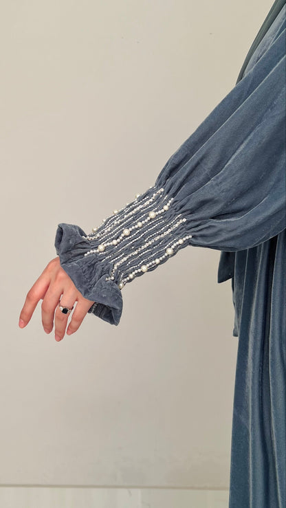 Gray dress with embellished sleeves on a plain background