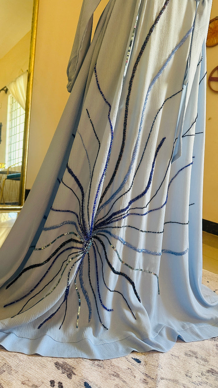 Light blue dress with black and white abstract pattern on a hanger