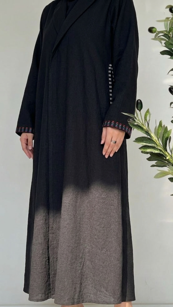 Black and gray gradient dress worn by a person with a plant in the background