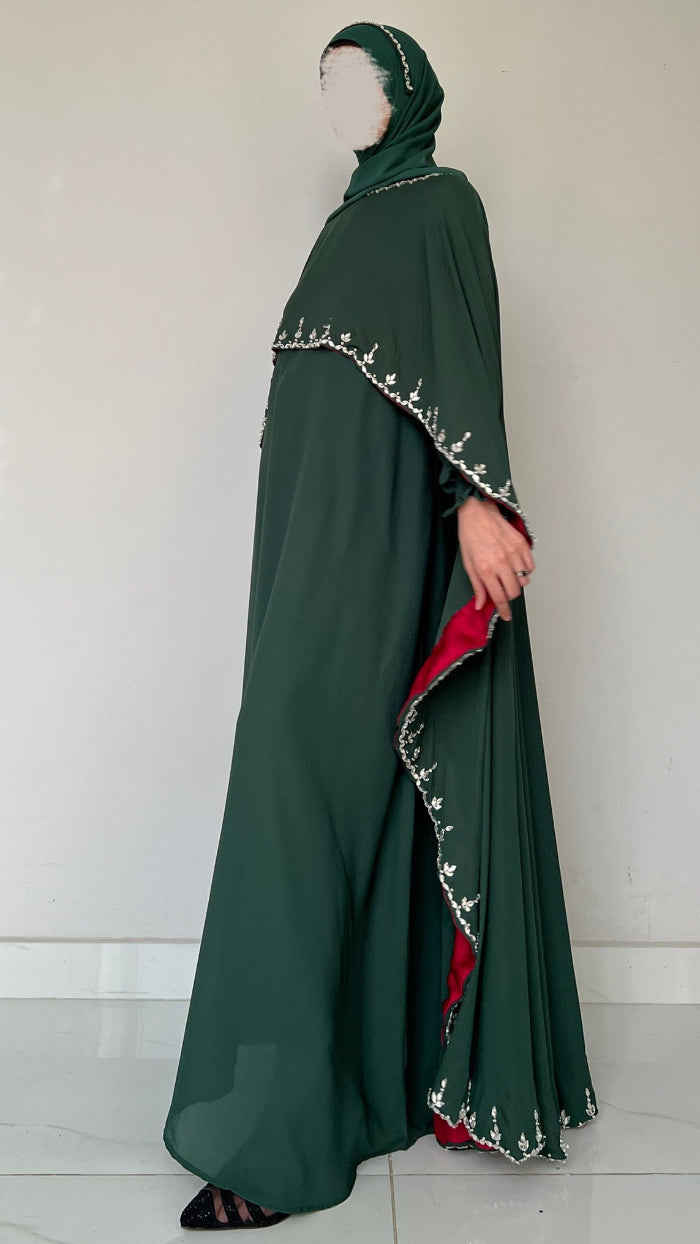 Green abaya with red inner lining on a white background