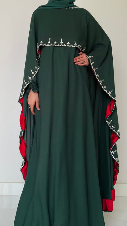 Dark green abaya with red and white embroidery on a white background
