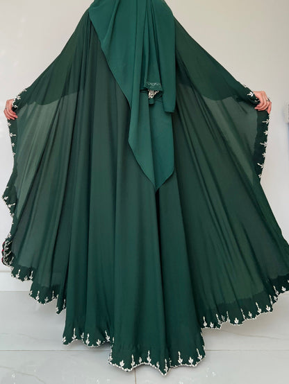 Green abaya with white trim on a white background